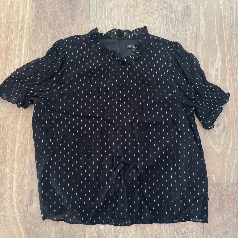 J. Crew black mockneck ruffle top with gold polka dot design